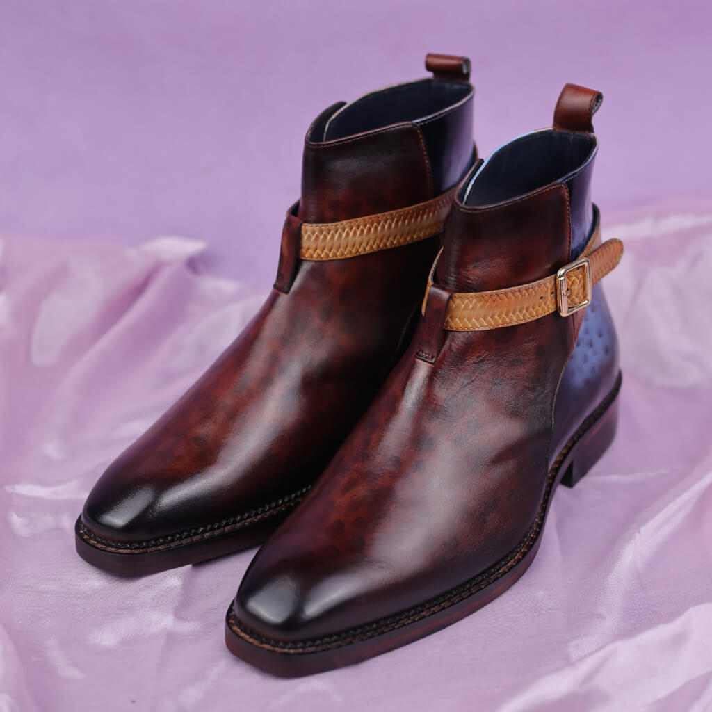 A pair of Cavalier Crest Marble Patina Boots crafted from Argentina white crust leather with a distinctive marble patina effect. Featuring a durable Italian leather sole with a leather welt, luxurious leather insole, and memory foam cushioning for exceptional comfort, these boots are perfect for various occasions and come with a 6-month warranty.