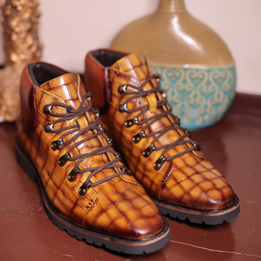 A pair of Savoy Chukka Boots in Curry Croco Leather, featuring a premium crocodile-embossed leather upper. The boots are designed with a lightweight EVA sole for superior grip and flexibility, ideal for bike riding, hiking, and outdoor exploration. Inside, they offer a cushioned insole for all-day comfort, blending rugged style with exceptional comfort for any adventure.