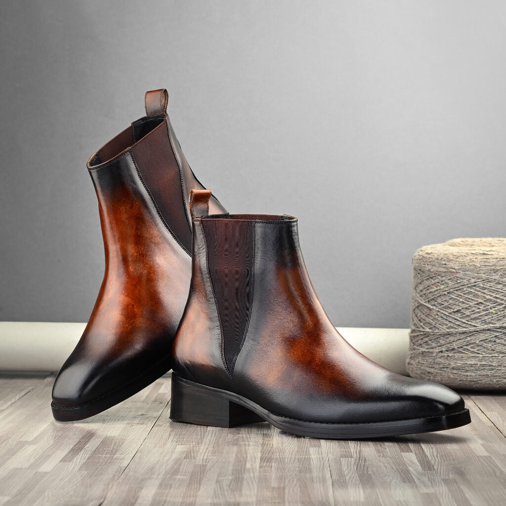 "Marble-Gloss Masterpiece Chelsea Boots by Mille Dollari—hand-patina finish with a rich marble-like gloss in warm cognac, offering sophistication and timeless style."