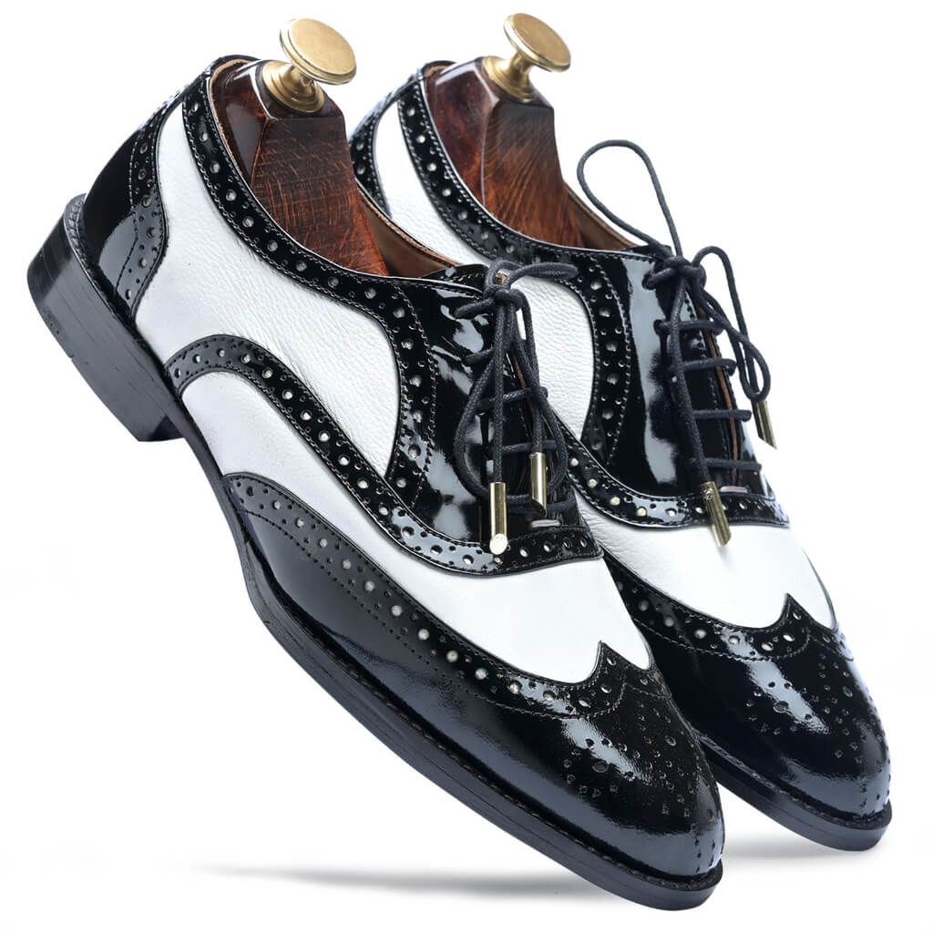 The London Brogues in Black & White – handcrafted leather shoes with intricate perforations, detailed stitching, and a contrasting two-tone design for a stylish, timeless appeal