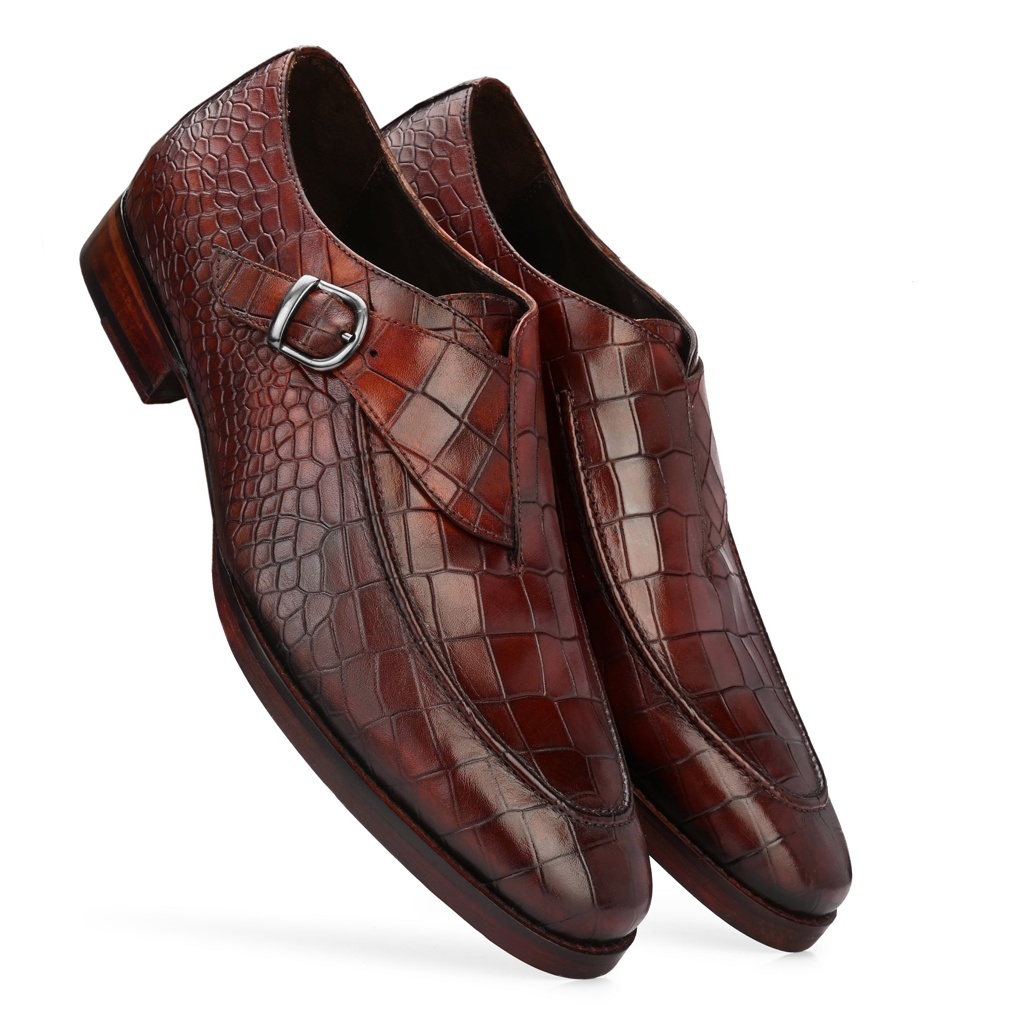 A pair of Regent Newsberry brown single monk strap shoes, crafted from full-grain Argentinian Rare White Crust leather with Blake-stitched construction. The leather sole features a rubber insert for durability and grip, while the interior is lined with luxurious French sheepskin for comfort.