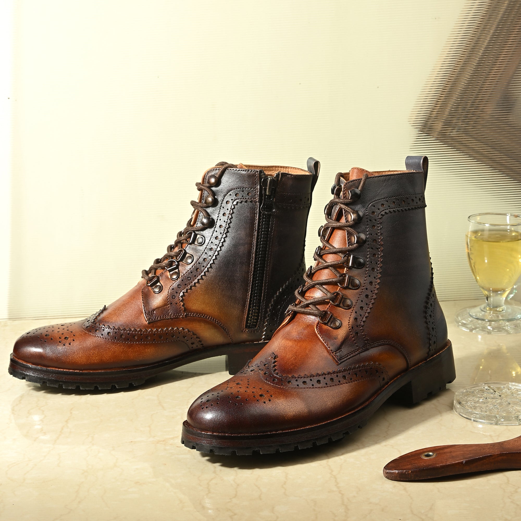 Men’s brown wingtip brogue leather lace-up boots with burnished finish and rugged sole