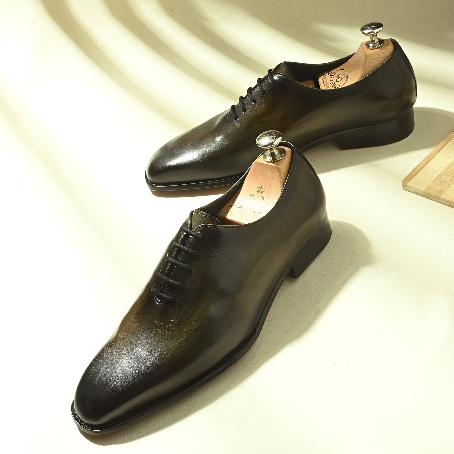 Men’s hand-patina leather wholecut Oxford shoes with closed lacing.