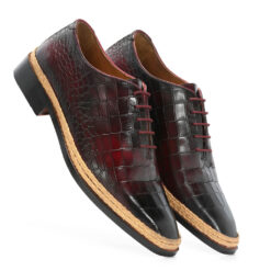 a distinguished lace-up shoe that combines classic design with modern craftsmanship. The upper is crafted from wine-colored croco-embossed leather