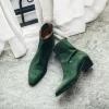 A pair of dark green suede leather Fiorina slip-on boots for men, featuring a sleek pointed-toe design and a convenient side zipper. These boots, part of the AW24 collection, exude sophistication with their rich suede texture and premium craftsmanship, ideal for elevating formal or casual looks.